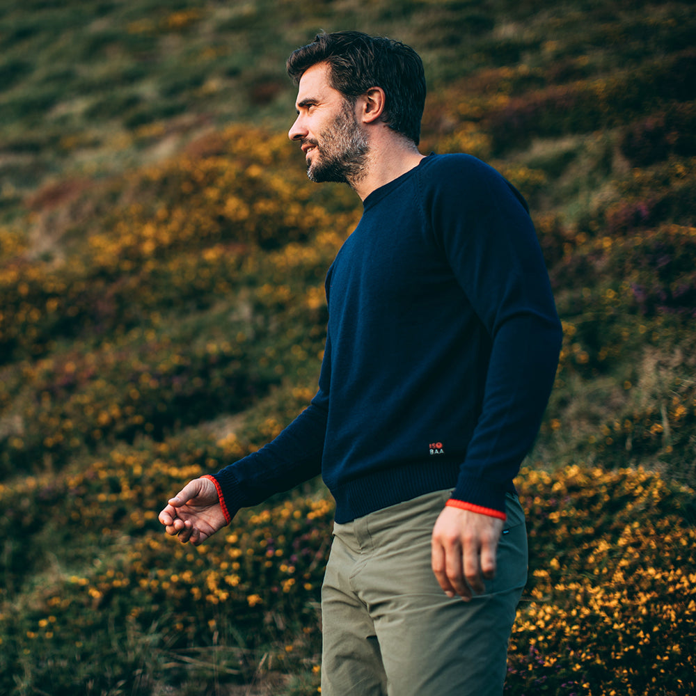 Isobaa | Mens Merino Crew Sweater (Navy/Orange) | Everyday warmth and comfort with our superfine 12-gauge Merino wool crew neck sweater. | Model: Duncan
