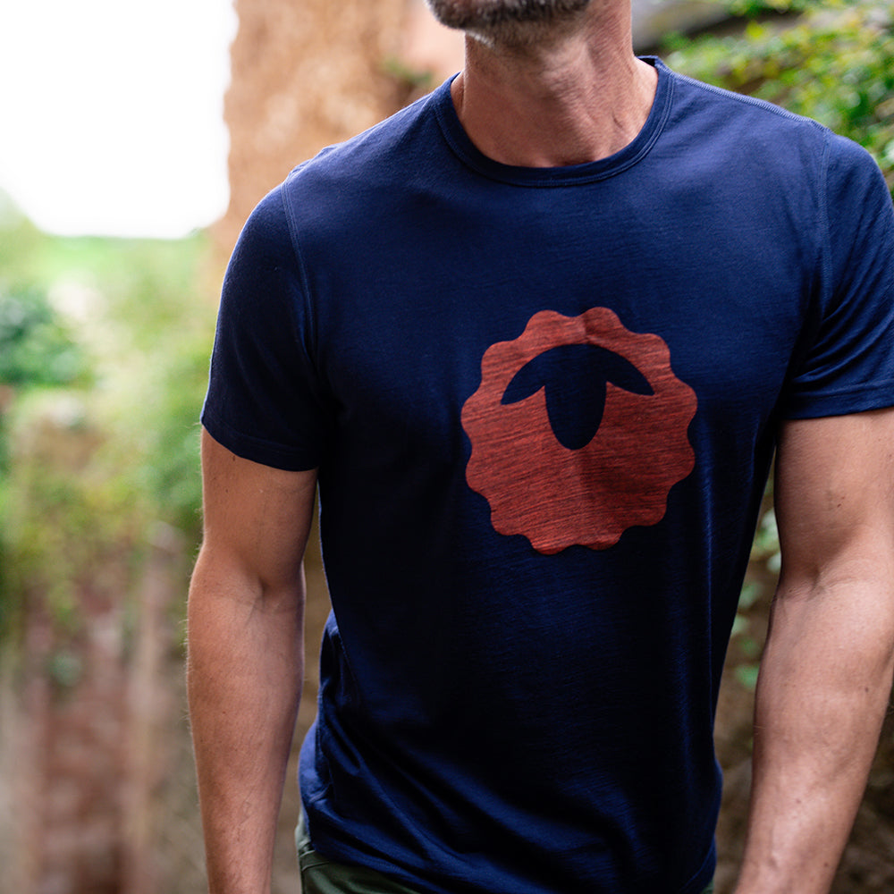 Isobaa | Mens Merino 150 Emblem Tee (Navy/Orange) | Conquer trails and city streets in comfort with Isobaa's superfine Merino T-Shirt. | Model: Ben