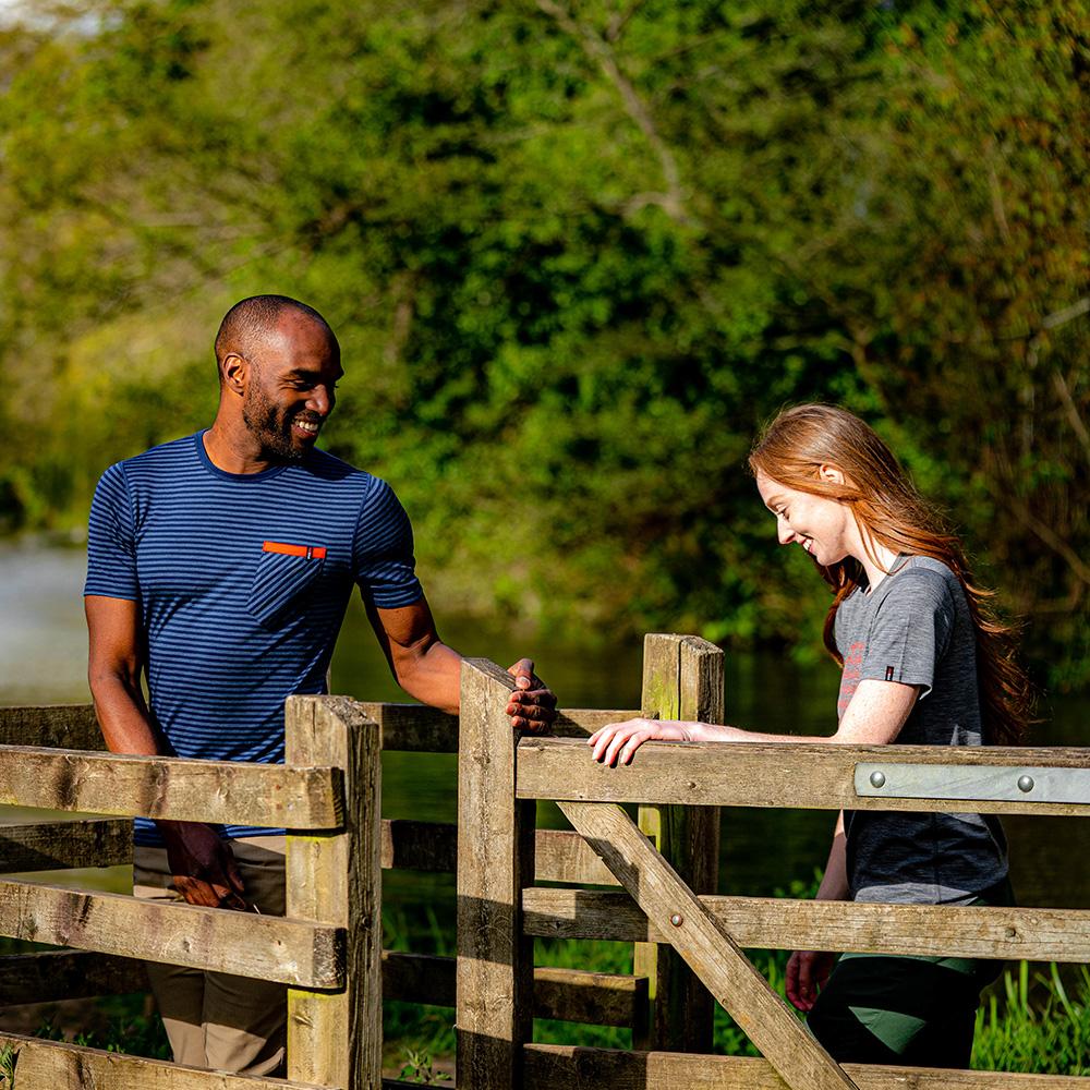 Isobaa | Mens Merino 150 Pocket Tee (Mini Stripe Navy/Denim) | Gear up for outdoor adventure with Isobaa's superfine Merino Tee – a perfect blend of comfort, practicality, and sustainable design. | Model: Michael