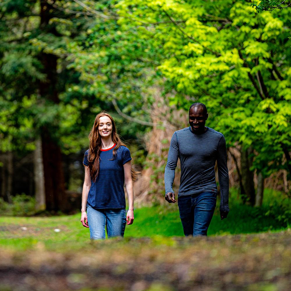 Isobaa | Womens Merino 150 Roll Sleeve Tee (Mini Stripe Navy/Denim) | Our superfine Merino T-shirt performs everywhere from outdoor adventures to coffee dates. | Model: Sophie