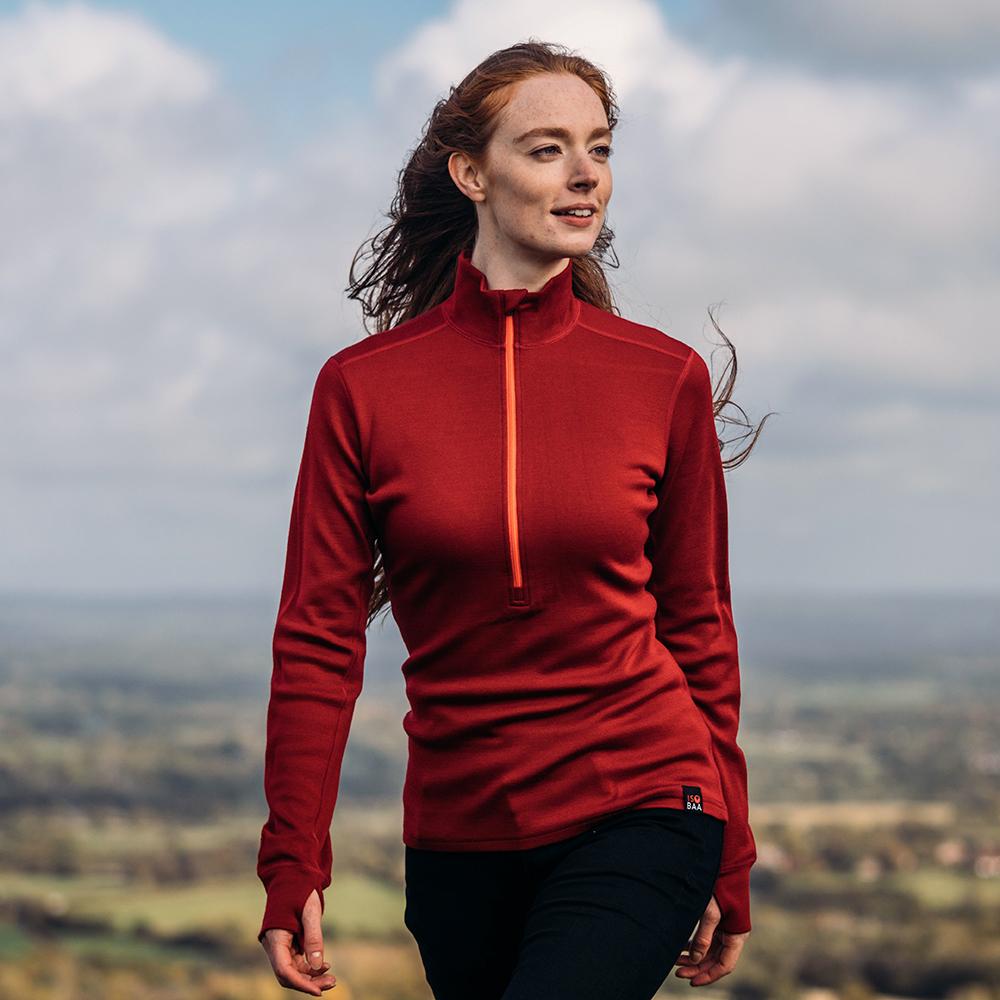 Isobaa | Womens Merino 320 Long Sleeve Half Zip (Red/Orange) | Conquer cold trails, blustery commutes, and unpredictable weather with the ultimate Merino wool half-zip top. | Model: Sophie